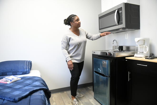 Director of Housing Benne Baker talks about the amenities of the kitchen in a unit at the Detroit Rescue Mission Ministries housing for veterans in Highland Park on Nov. 3, 2023. Sixty apartments were upgraded in partnership with Community Solutions, Rocket Community Fund and The Home Depot Foundation.