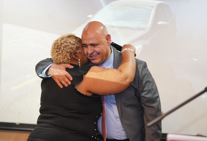 Lena Easley shares a warm embrace with Detroit Rescue Mission Ministries President and CEO Chad Audi, after a surprised Easley learned she was receiving a 2015 Black Ford Focus during the nonprofit's 115 Anniversary and Graduation Celebration on October 10.