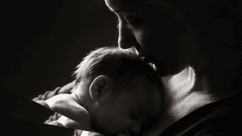 Mother holding small child in loving embrace